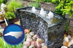 north-carolina map icon and bubbling water feature in a landscape