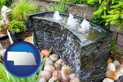 nebraska map icon and bubbling water feature in a landscape
